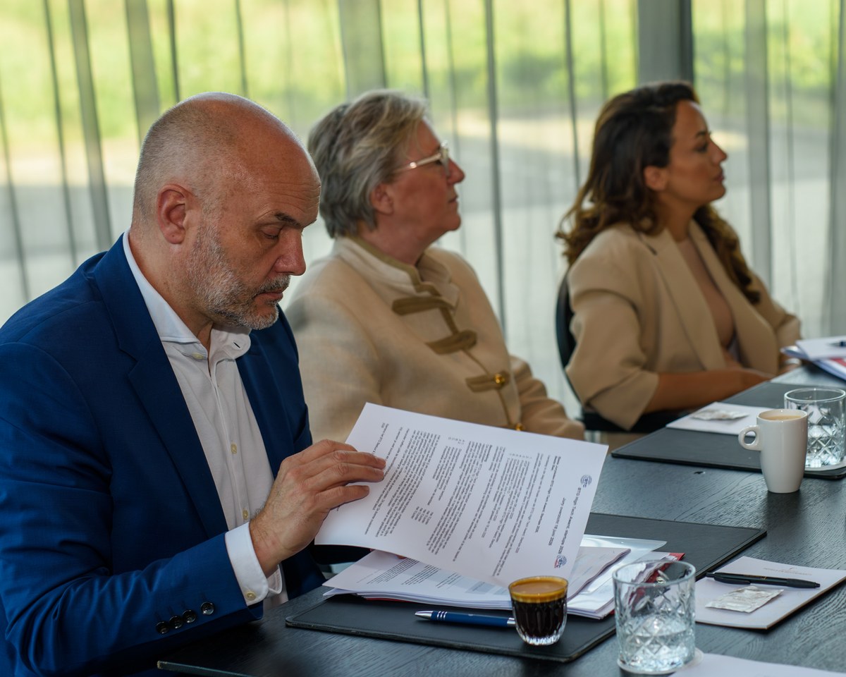 Jury members review notes at one of the tables.