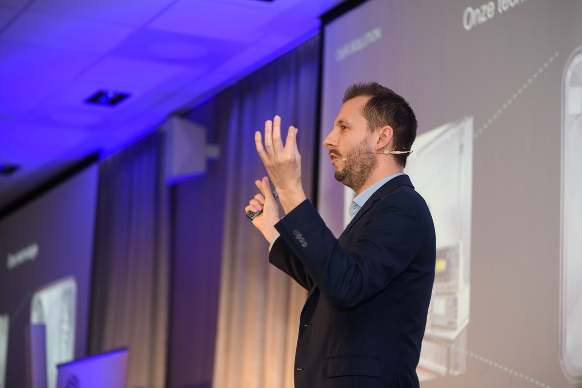 An awards candidate gestures during a presentation.