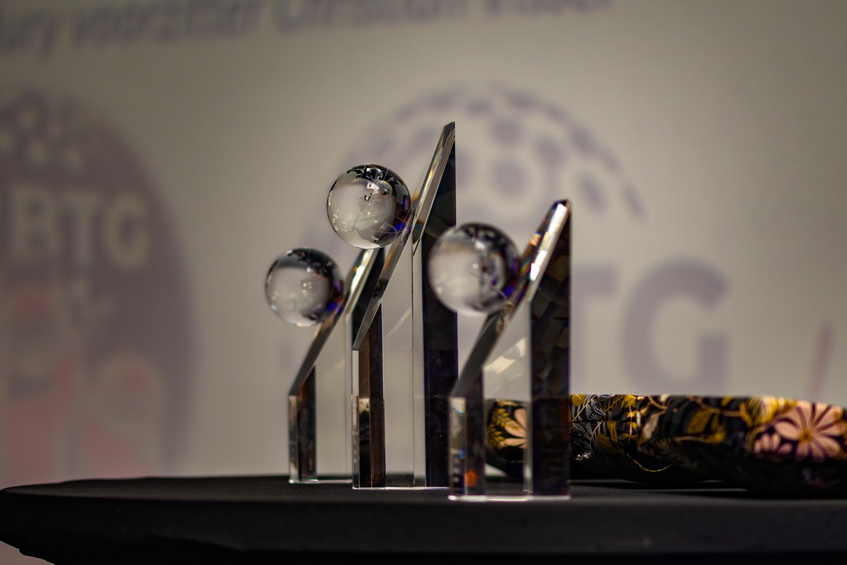 Three trophies stand ready for the awards ceremony.