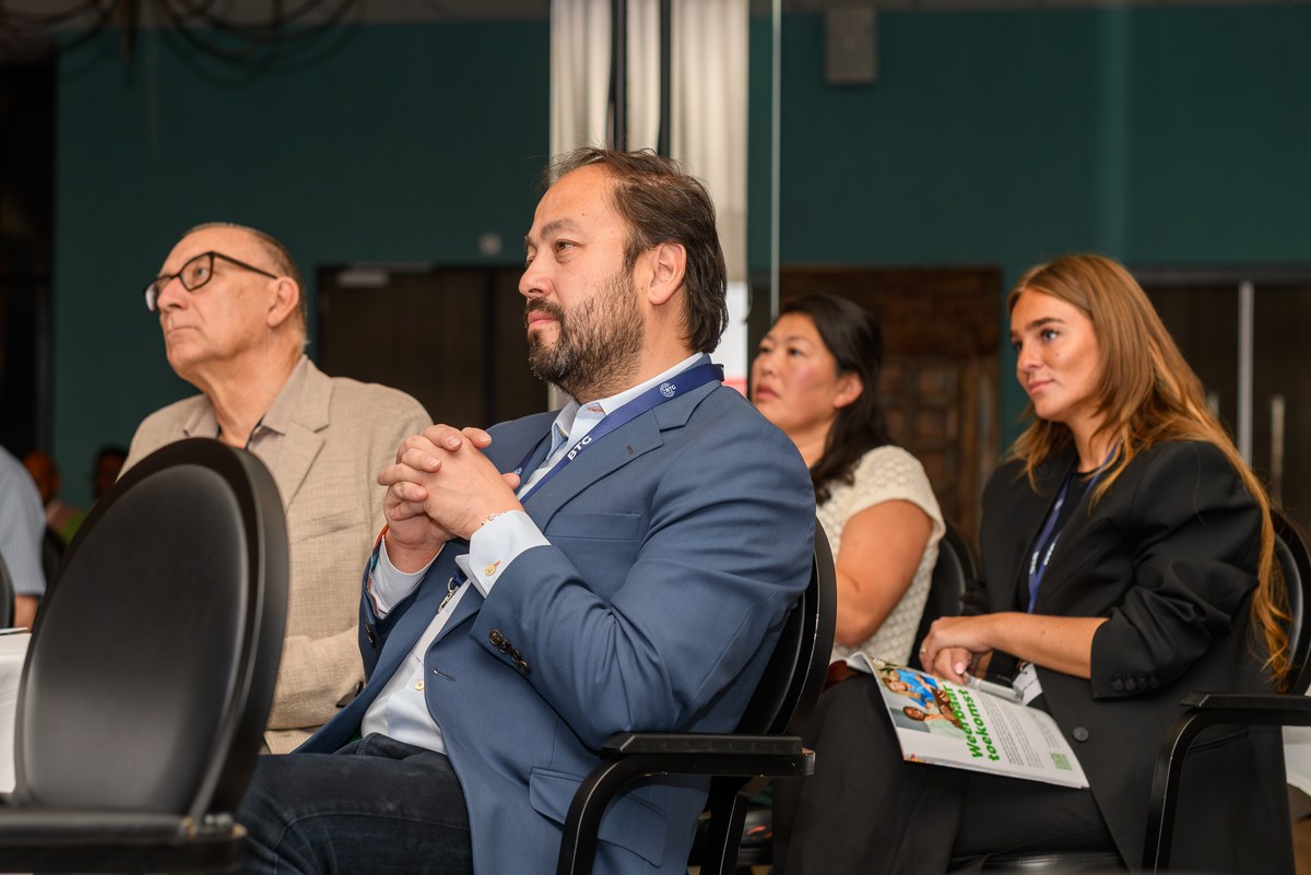 Seated guests follow the programme attentively.