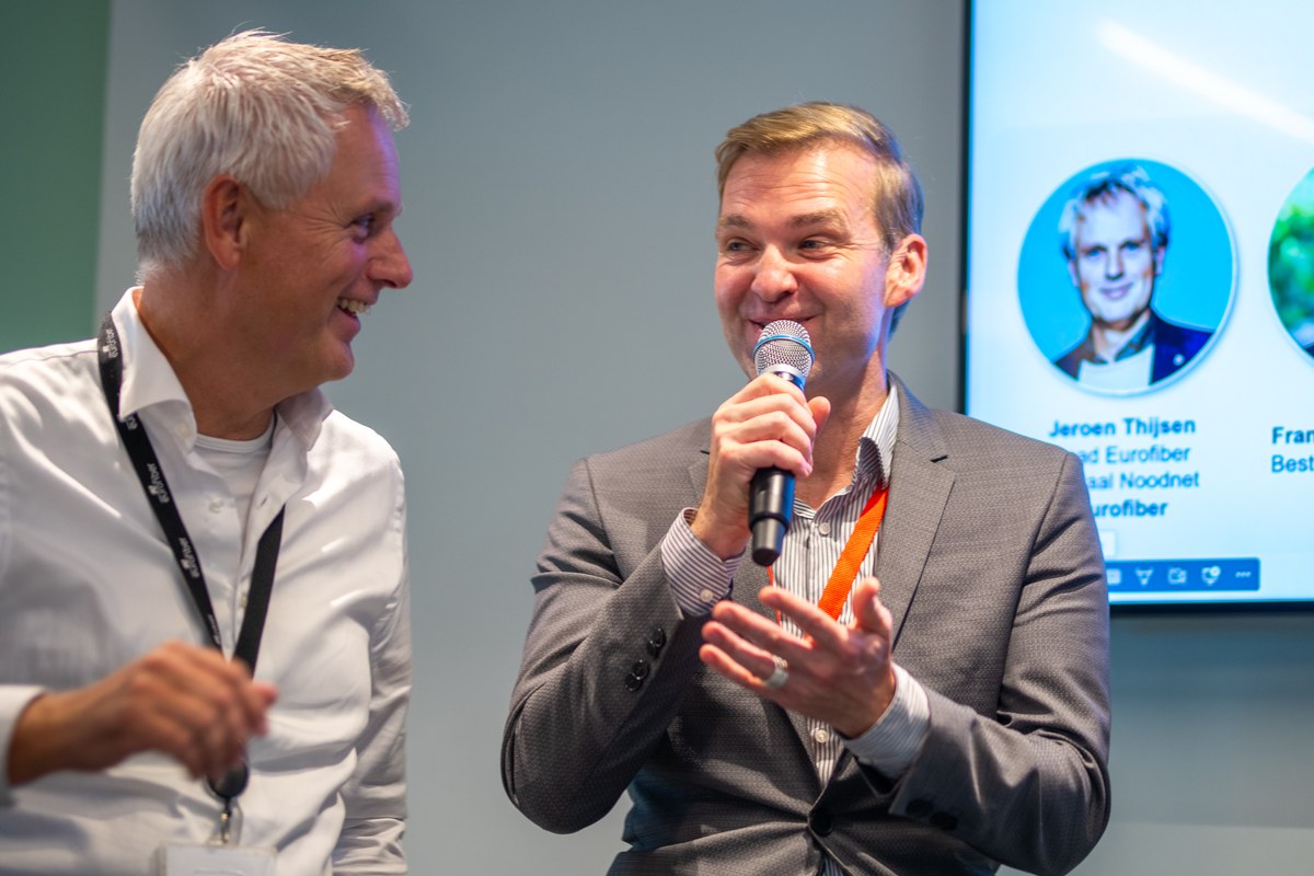 Two men share a smile during the panel discussion.