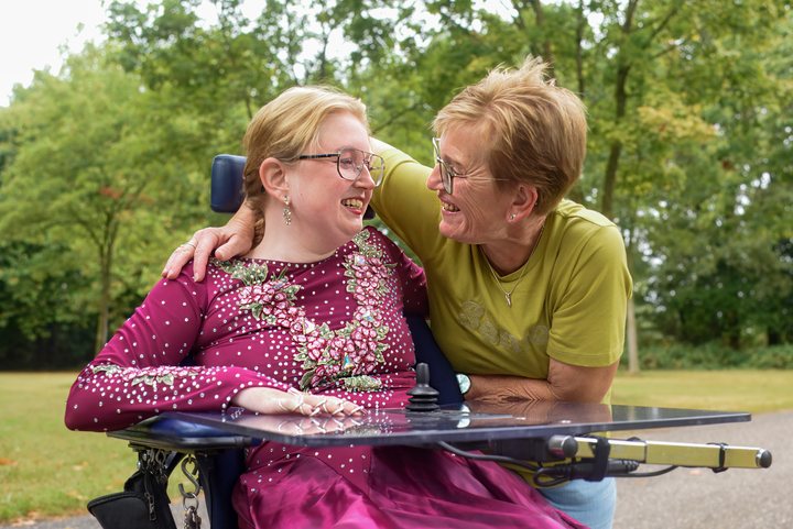 A woman and a companion share a smile.
