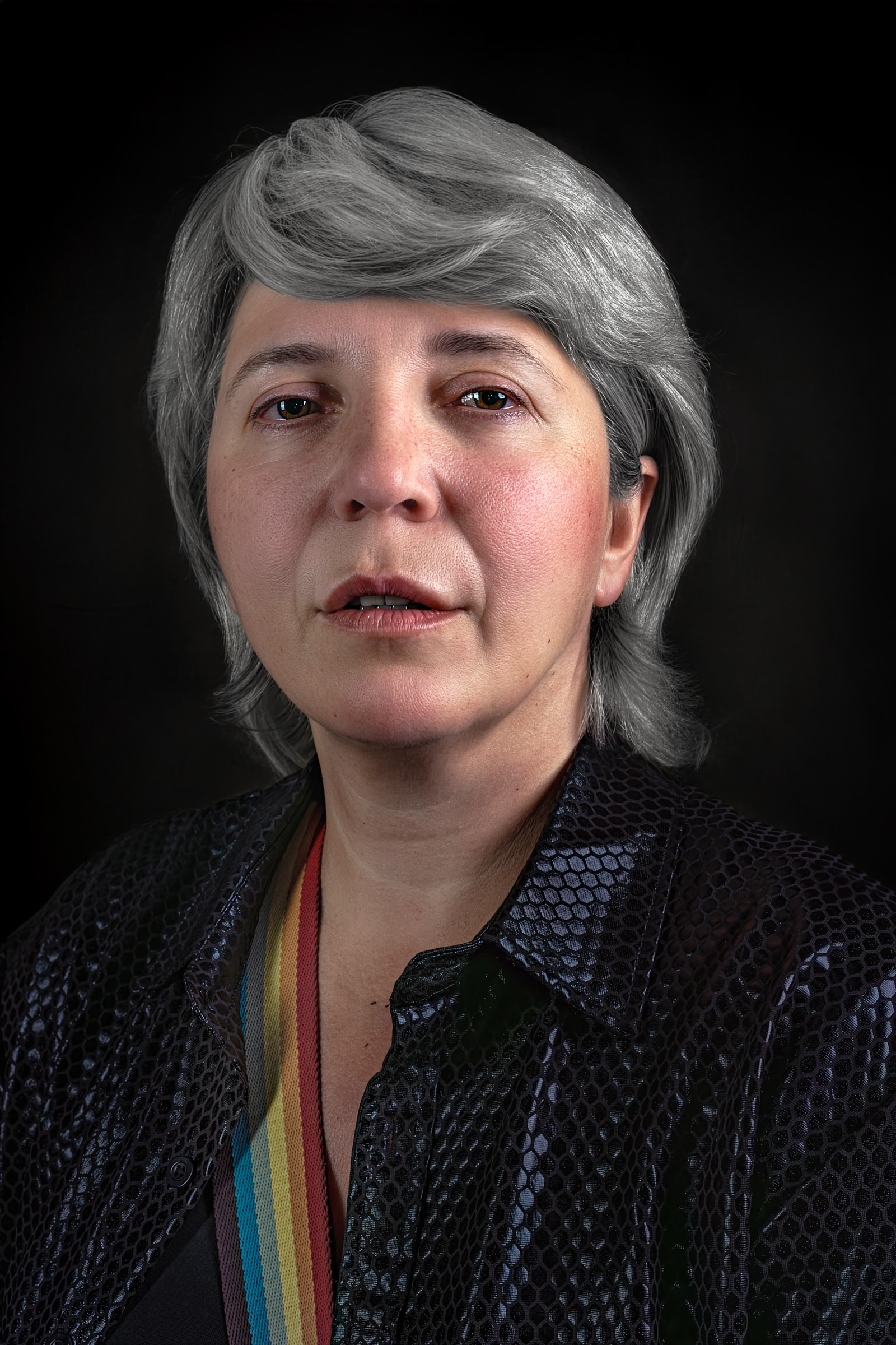 Portrait of a silver-haired woman in a textured black jacket against a dark background.