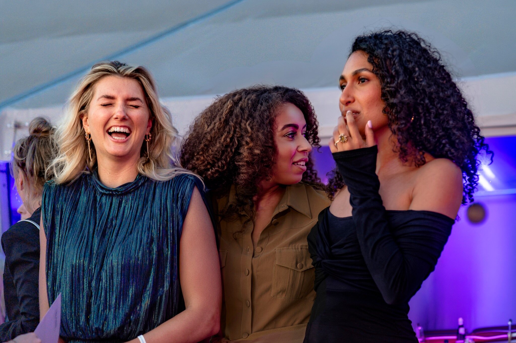Drie gasten delen een spontaan moment tijdens een live-evenement