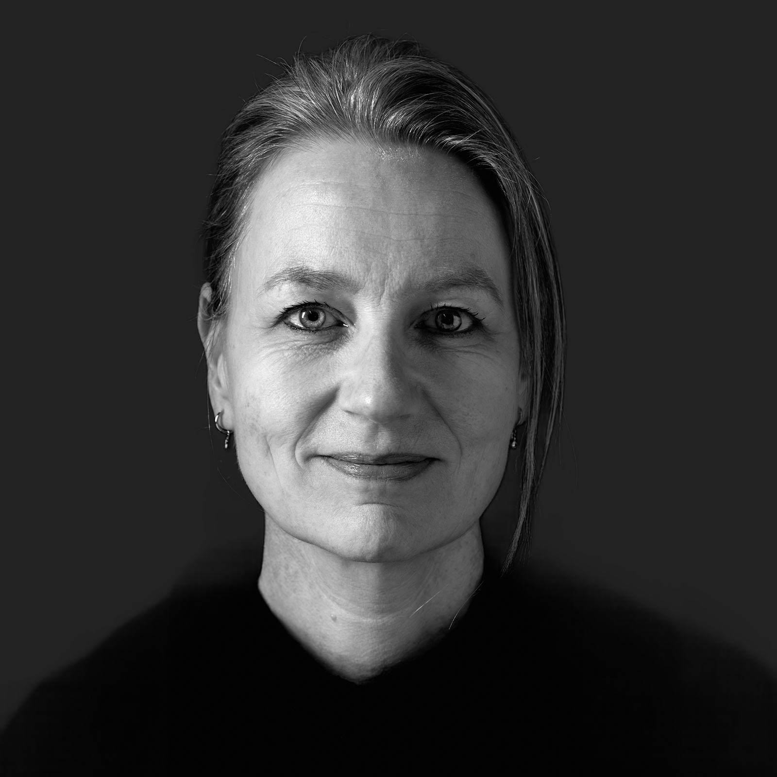 Black-and-white Colbe team portrait against a softly raised dark background