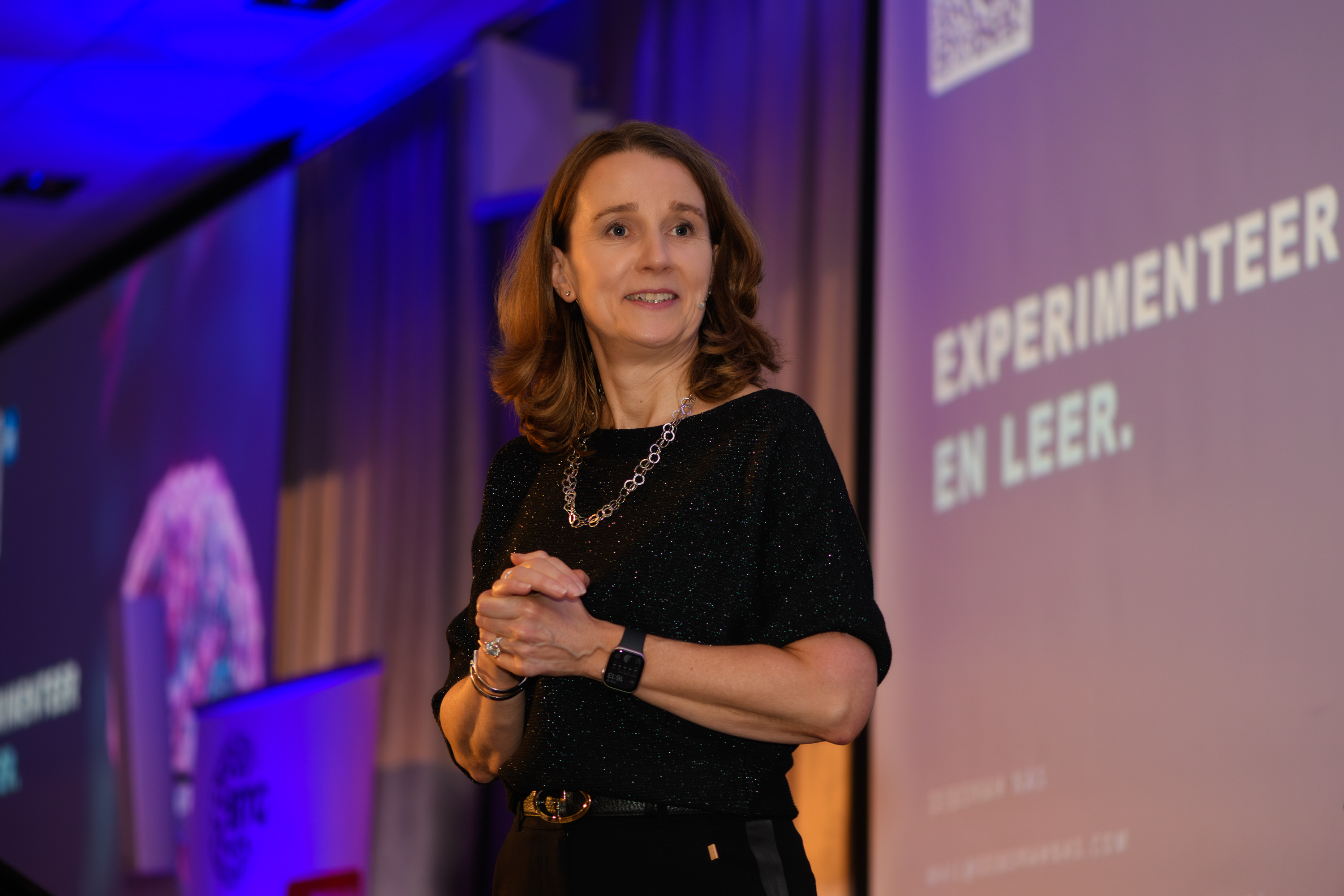 Speaker on stage at the BTG Business event, facing the camera