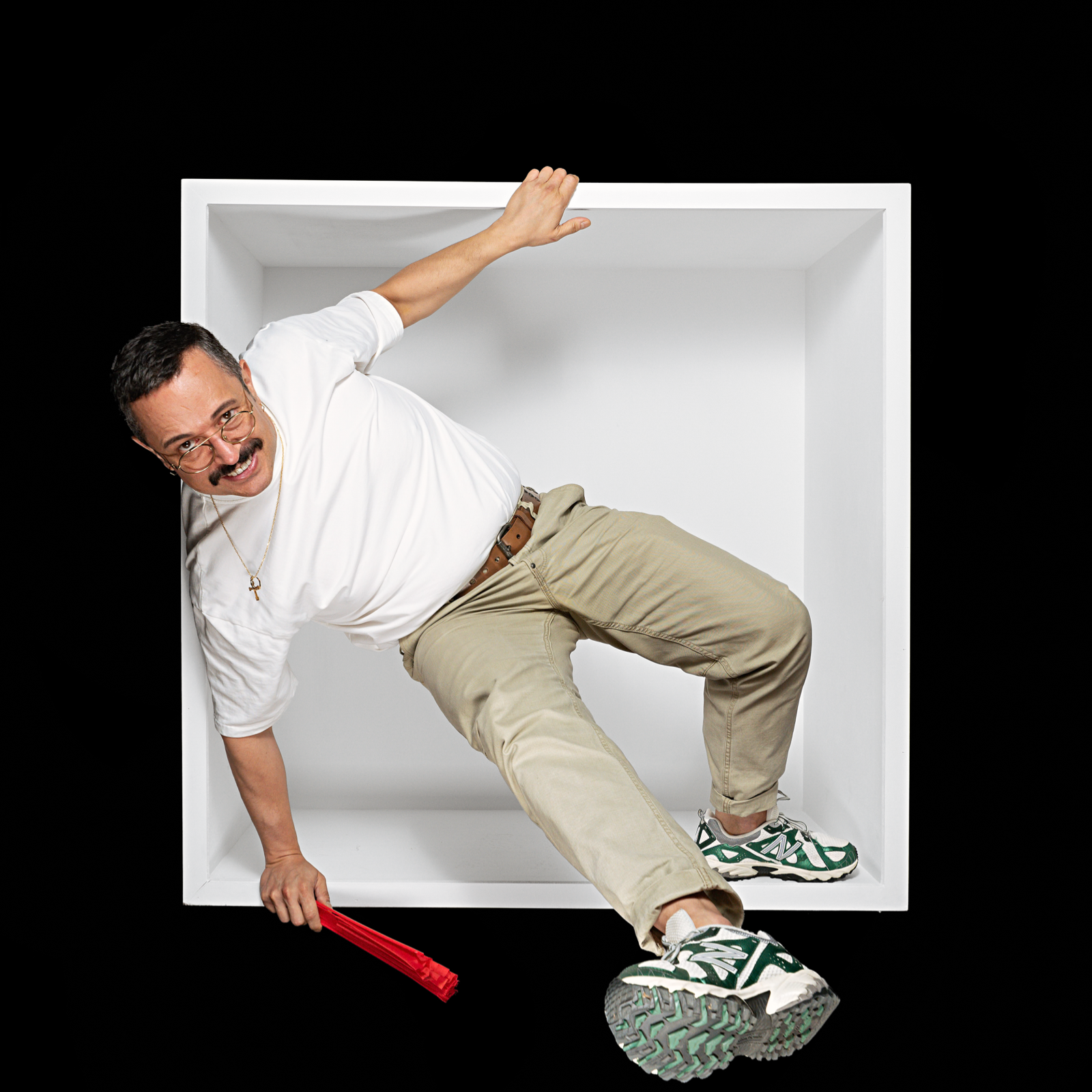 Man in a white shirt leaning out of a white box